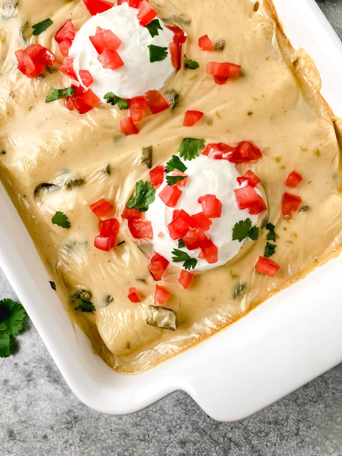 Corner view of enchiladas in a pan.