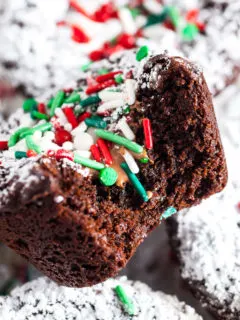 Close up view of powdered sugar and sprinkles on a brownie.