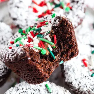 Close up view of powdered sugar and sprinkles on a brownie.