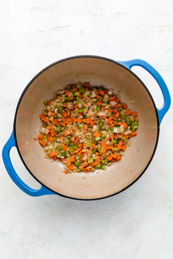 Sauteed vegetables in a Dutch oven.