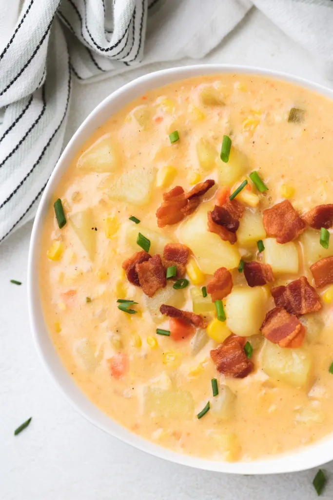Top down view of potato corn chowder with bacon.