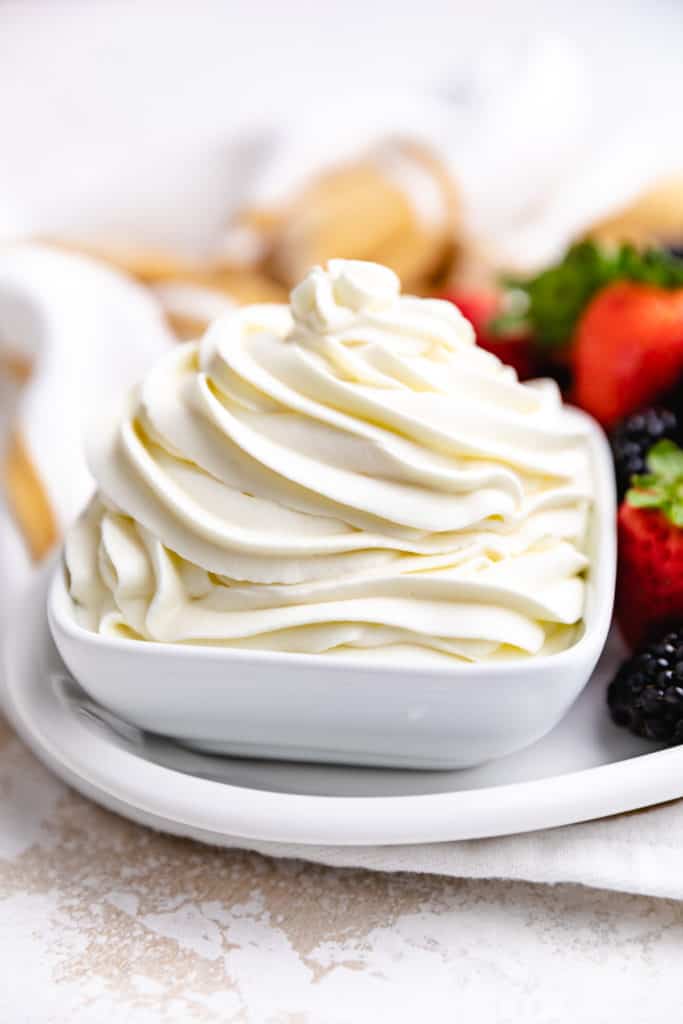 Side view of mascarpone whipped cream in a bowl.