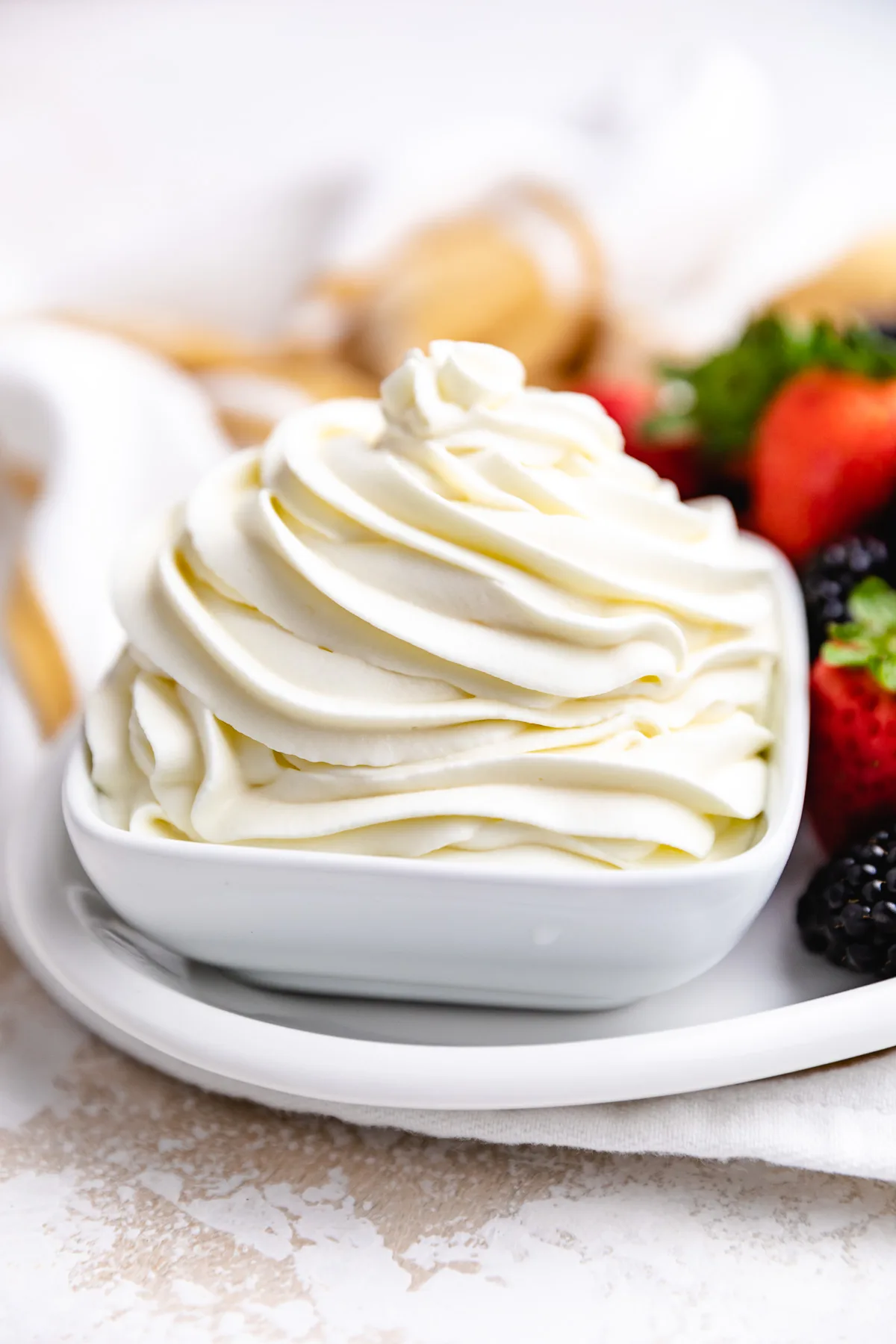 Side view of mascarpone whipped cream in a bowl.