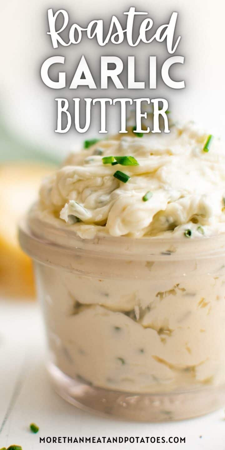 Jar filled with roasted garlic butter and chives.