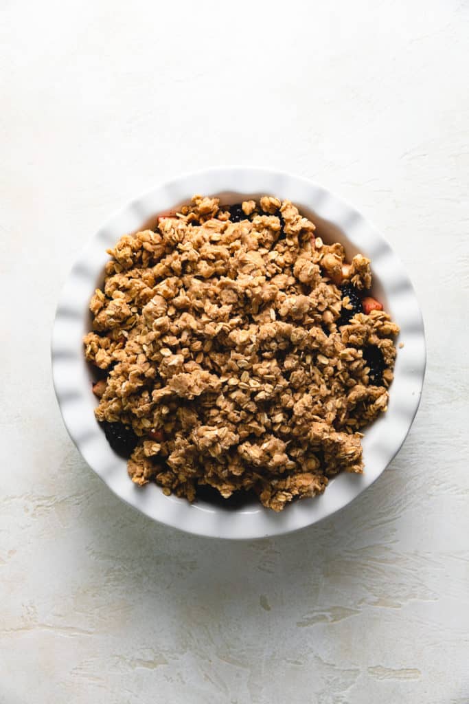 Top down view of crumble topping on fruit.