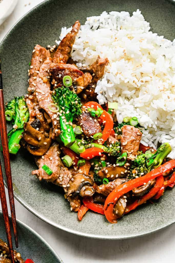 Close up view of sauteed beef, broccoli, and veggies with rice.