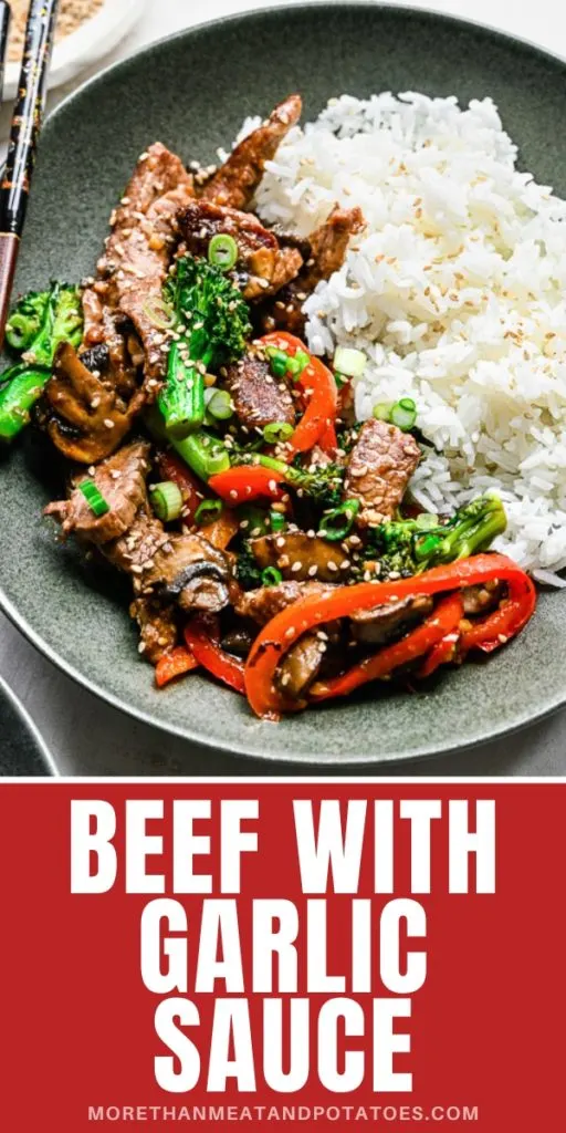 Close up view of beef with garlic sauce in a gray plate.