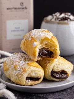 Stack of chocolate filled pastry on a plate.