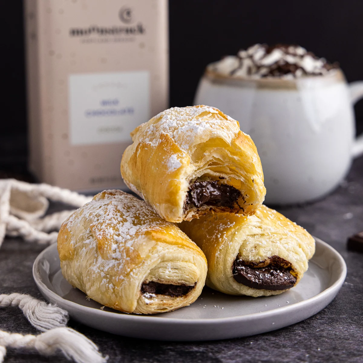 Stack of chocolate filled pastry on a plate.