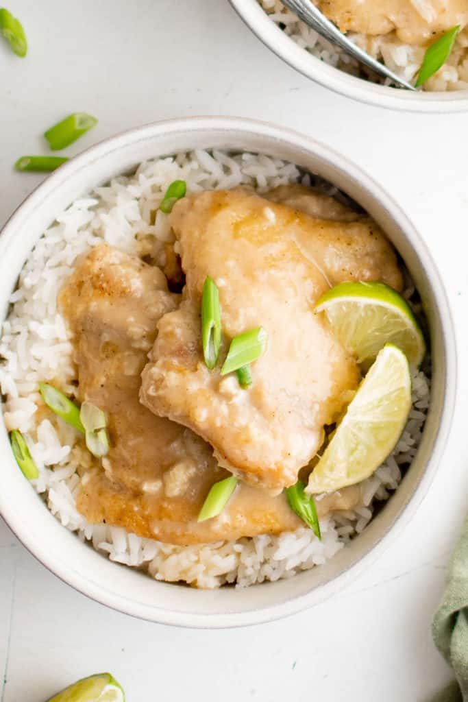 Lime wedges on top of cooked chicken thighs.