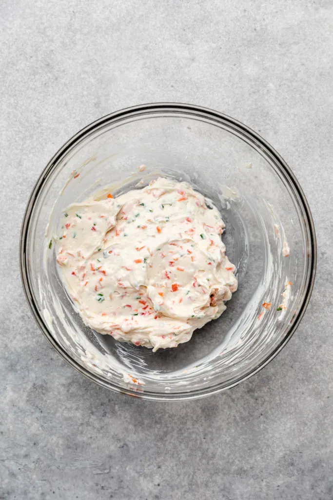 Garden vegetable cream cheese in a glass bowl.