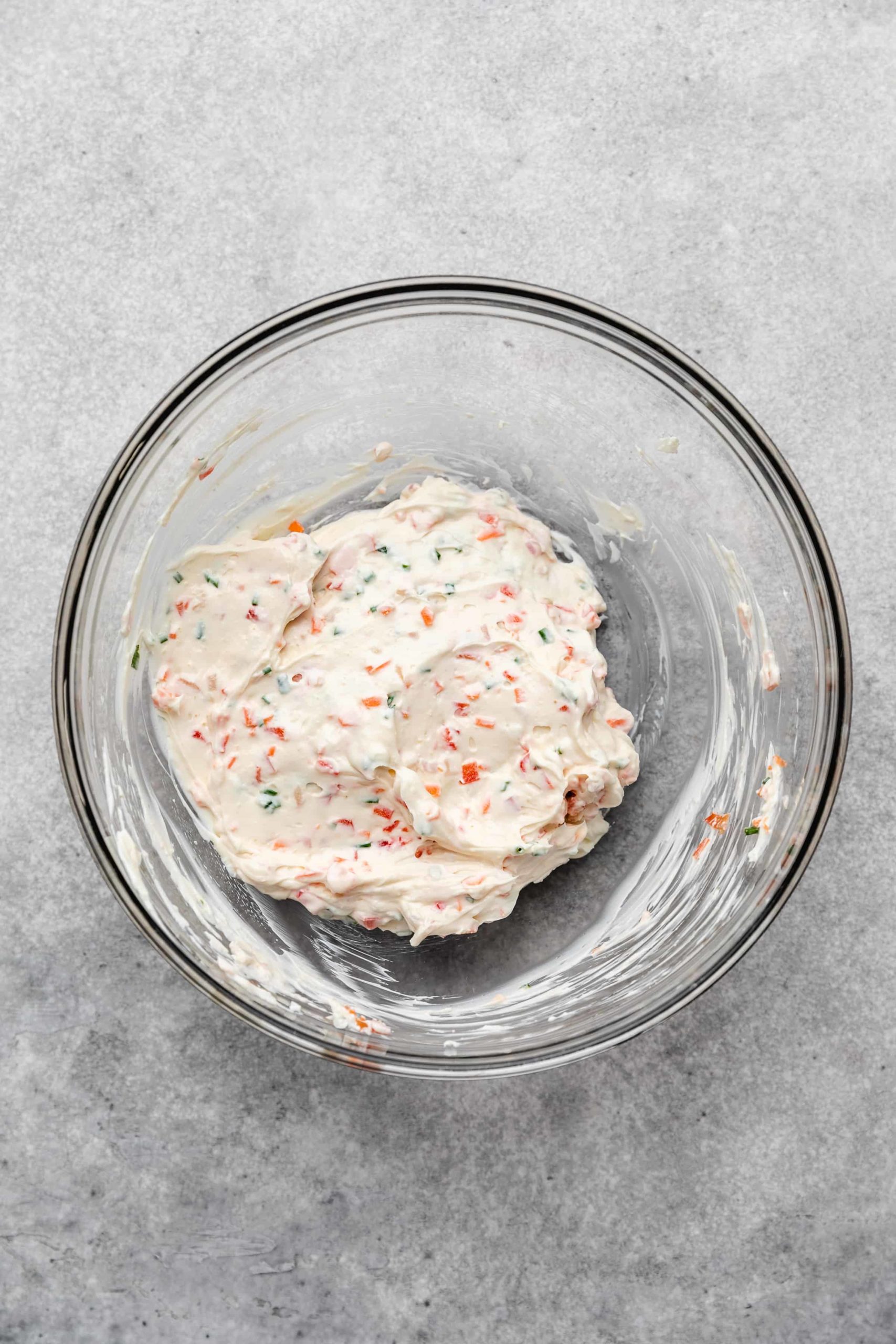 Garden vegetable cream cheese in a glass bowl.