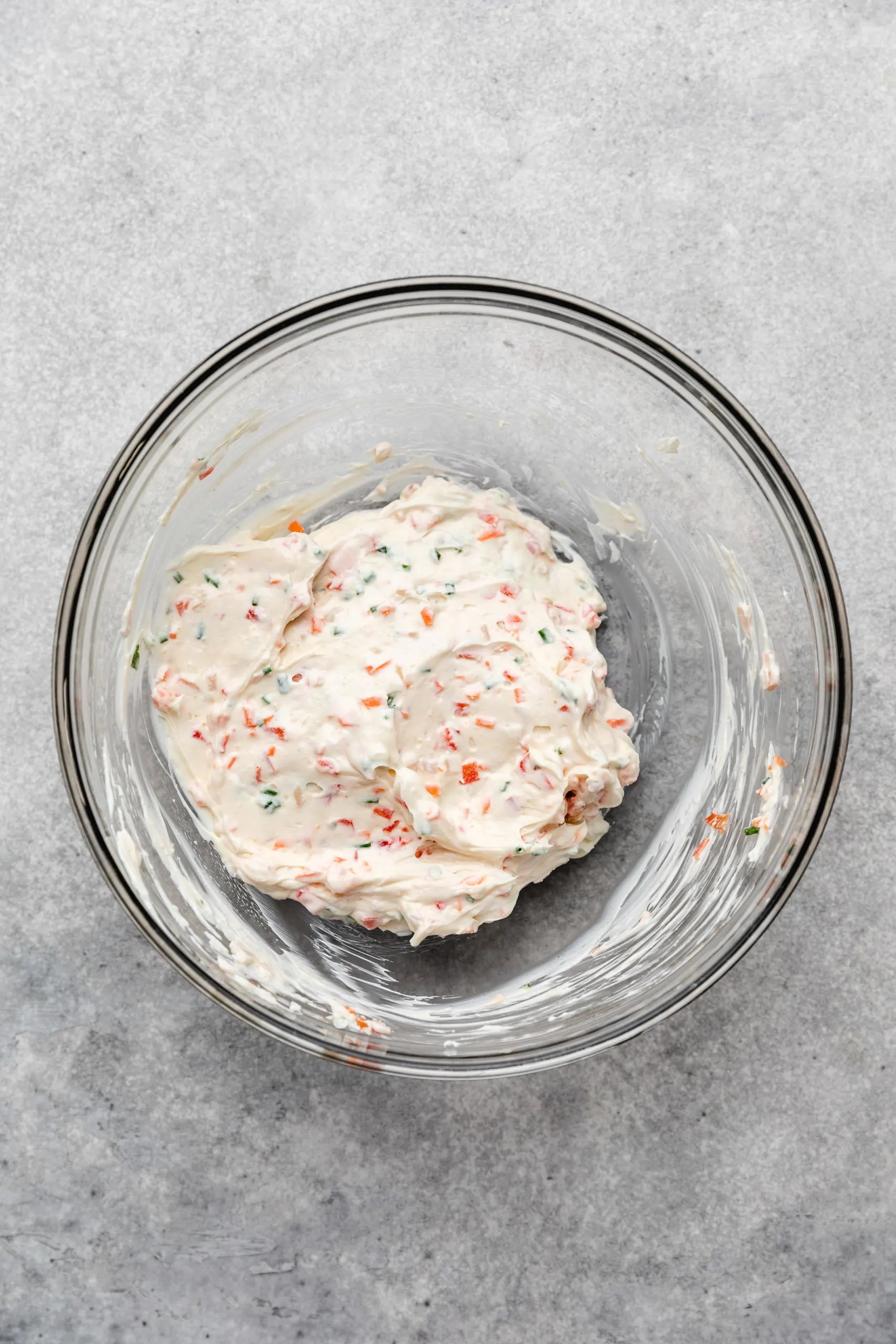 Garden vegetable cream cheese in a glass bowl.