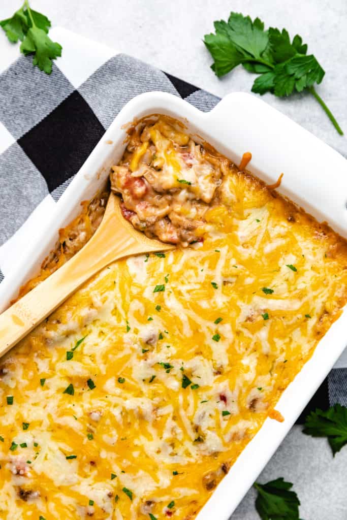 Top down view of a cheesy casserole with rice and ground beef.