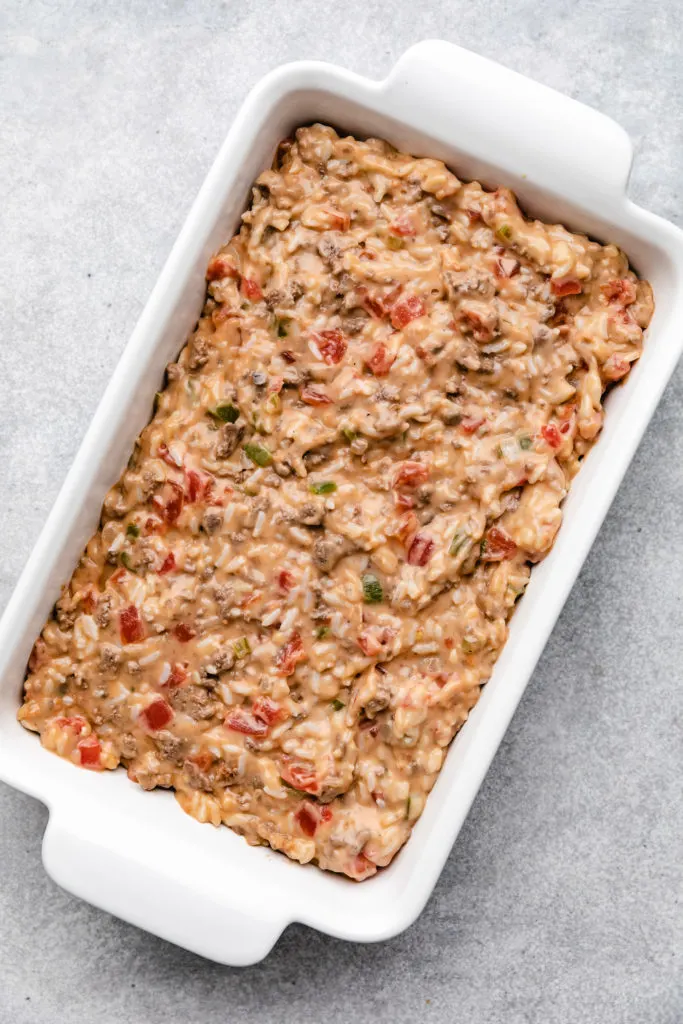 Rice and hamburger casserole in a white baking dish.