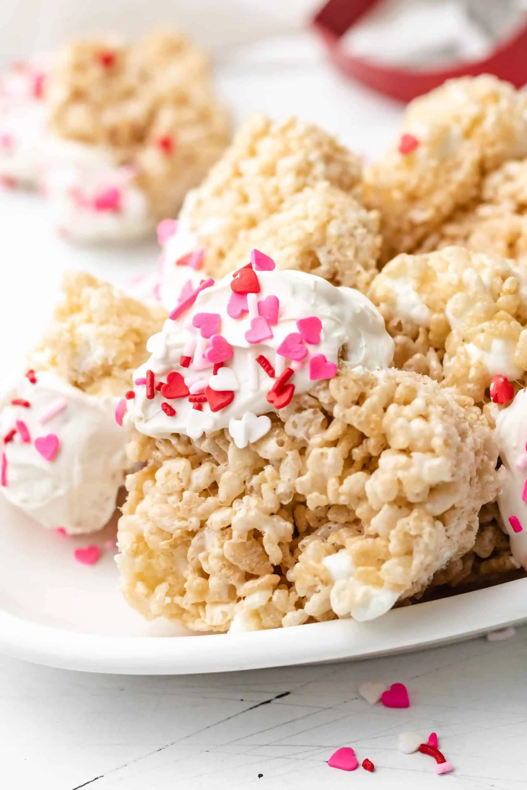 Heart shaped marshmallow treat on a white platter.