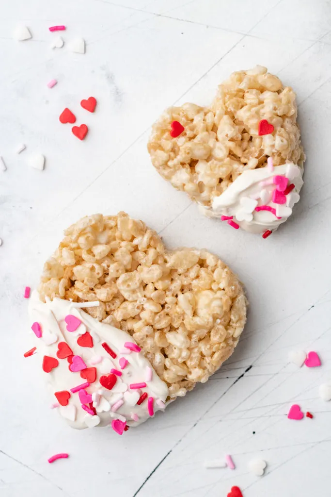 Large and small heart shaped cereal treats with sprinkles.