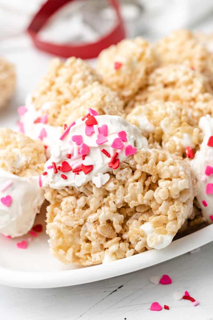 White dish filled with rice krispie treats with sprinkles.