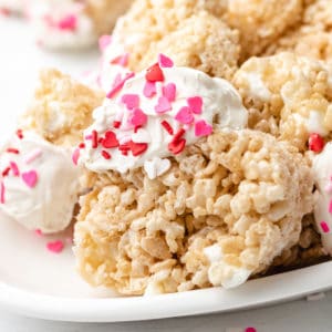 Side view of a heart shaped rice krispie treat with sprinkles.