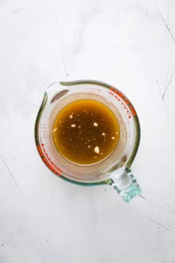 Brown sugar, maple syrup and butter mixture in a measuring cup.