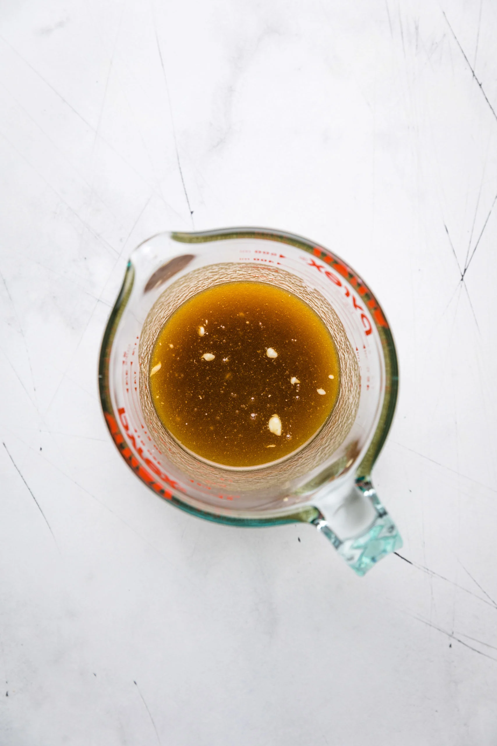 Brown sugar, maple syrup and butter mixture in a measuring cup.