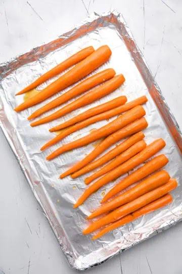 Whole carrots brushed with maple syrup and butter mixture.