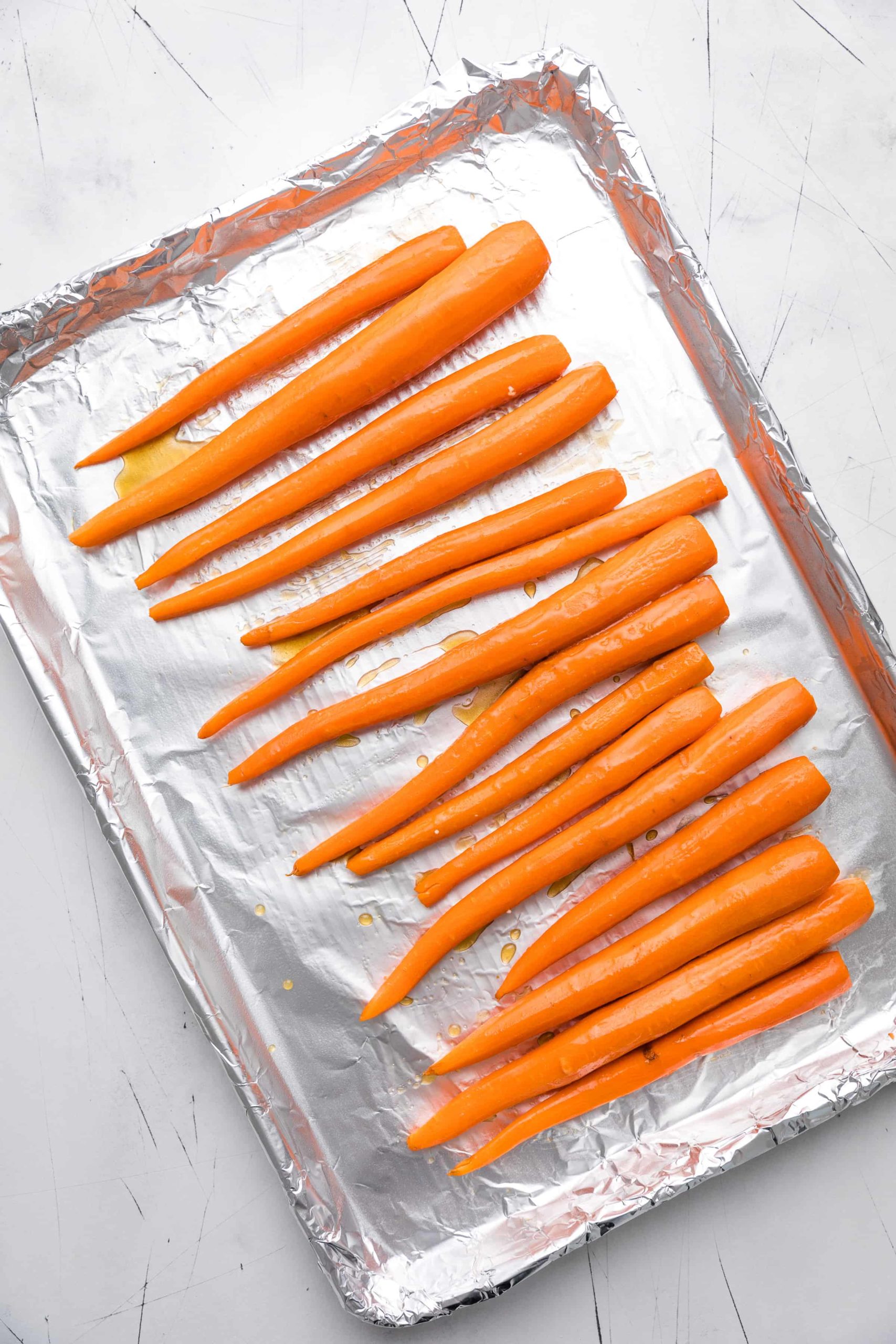 Whole carrots brushed with maple syrup and butter mixture.