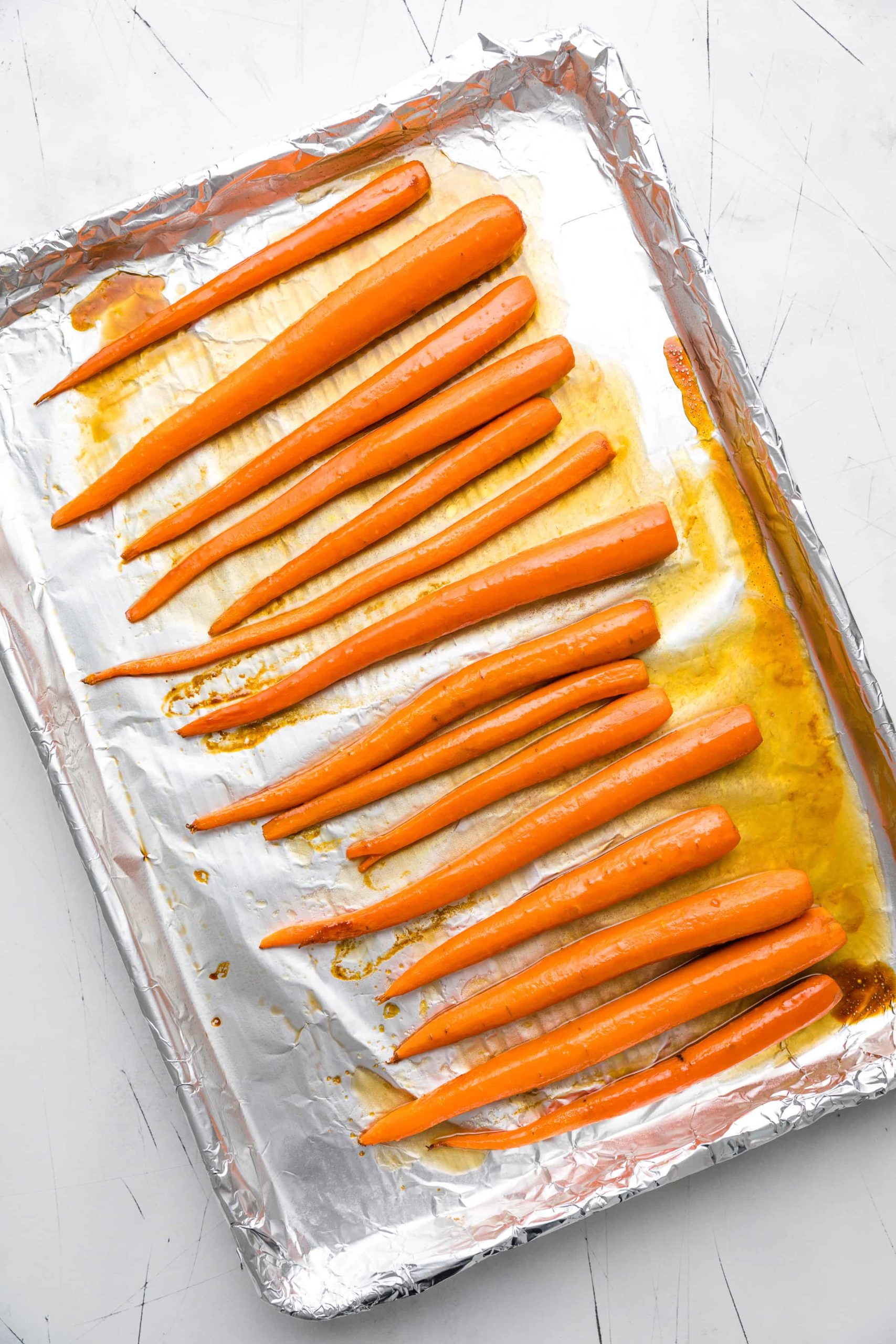 Carrots roasting on a baking sheet.