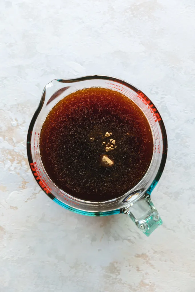 Measuring cup filled with marinade for pork chops.