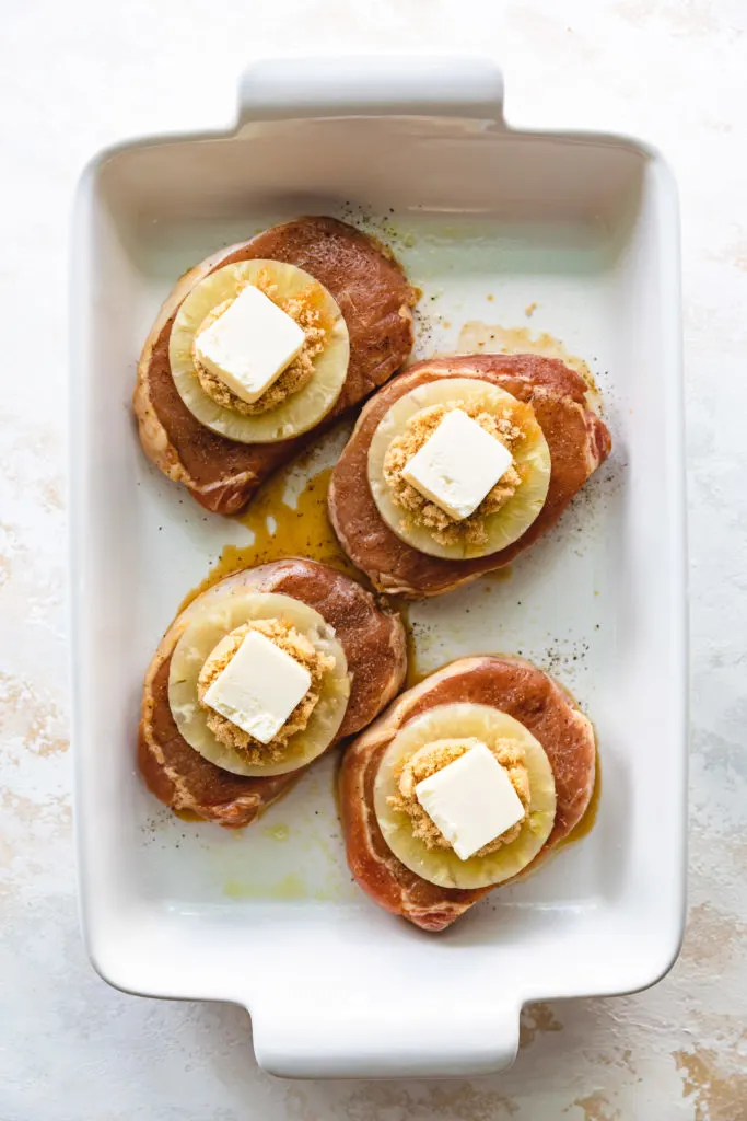 Pineapple, brown sugar, and butter on top of pork chops.