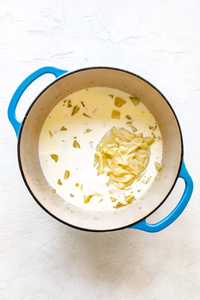 Heavy cream and milk added to a pan of potatoes.