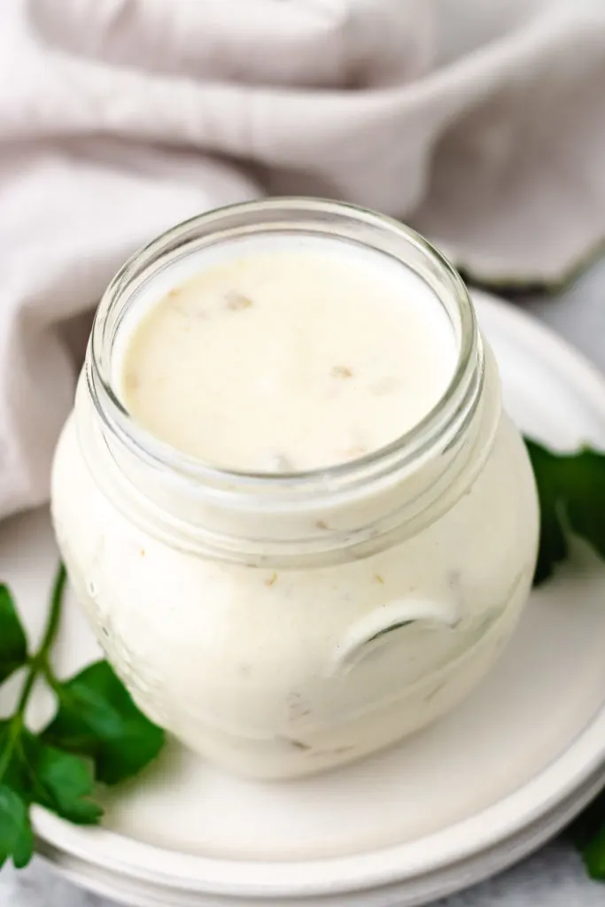 Angled view of a jar of creamy enchilada sauce.