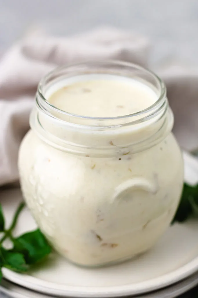 Side view of a jar of sour cream enchilada sauce.