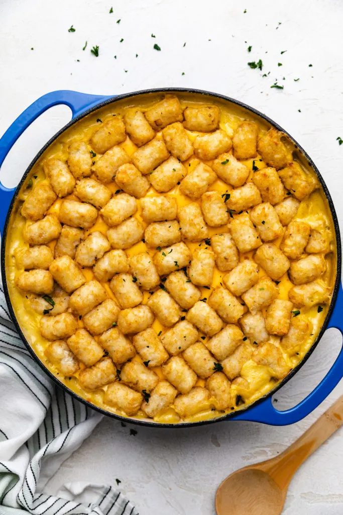 Top down view of chicken tater tot casserole in a blue pan.