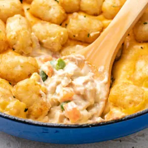 Close up view of chicken tater tot casserole in a pan.