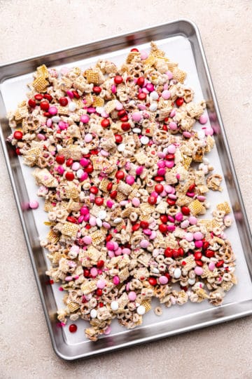 Valentine's snack mix on a baking sheet lined with parchment paper.