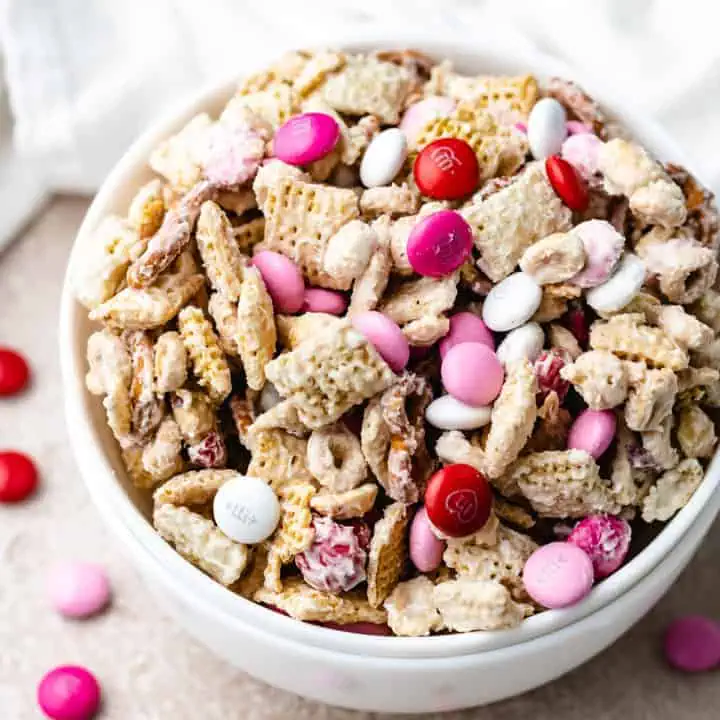 Close up view of a bowl of valentine's chex mix.