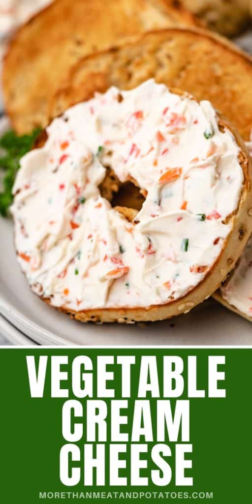 Close up view of a bagels on a plate with vegetable cream cheese.