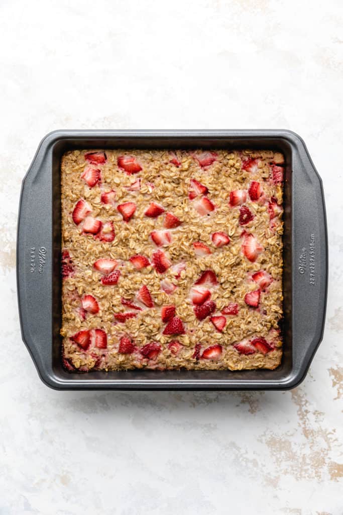 Strawberry baked oatmeal in a square pan.