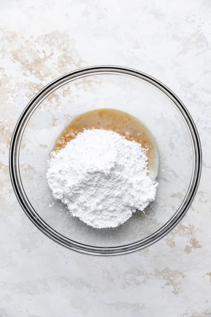 Powdered sugar and milk in a bowl.