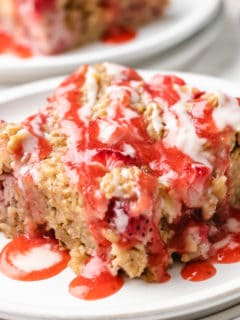 Close up view of a slice of baked oatmeal with strawberries.