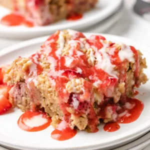 Close up view of a slice of baked oatmeal with strawberries.