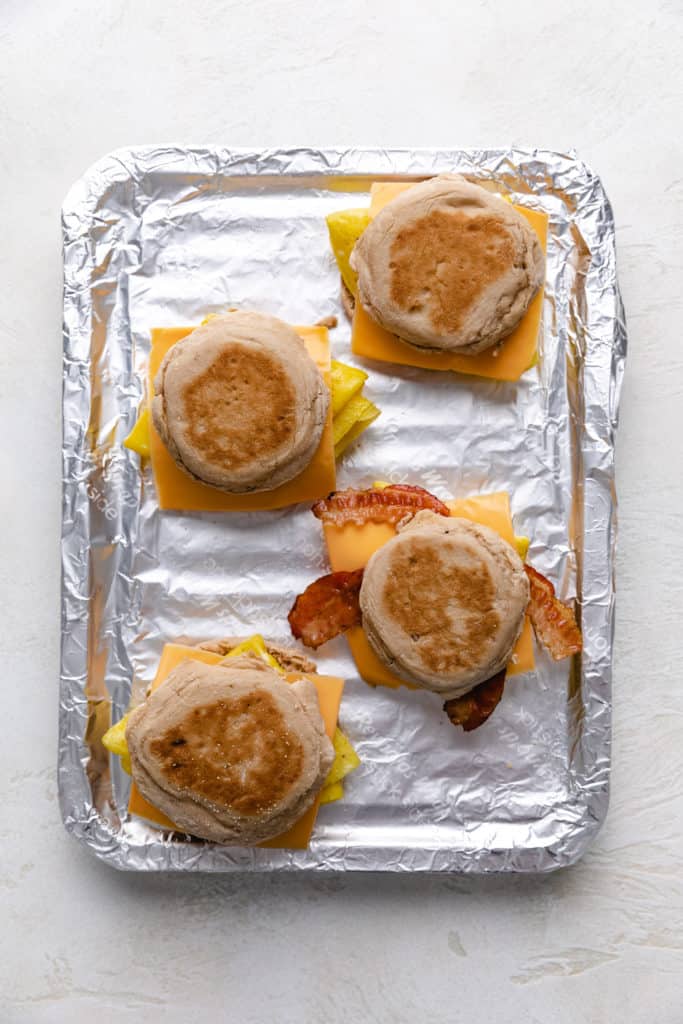 English muffin sandwiches on a pan.