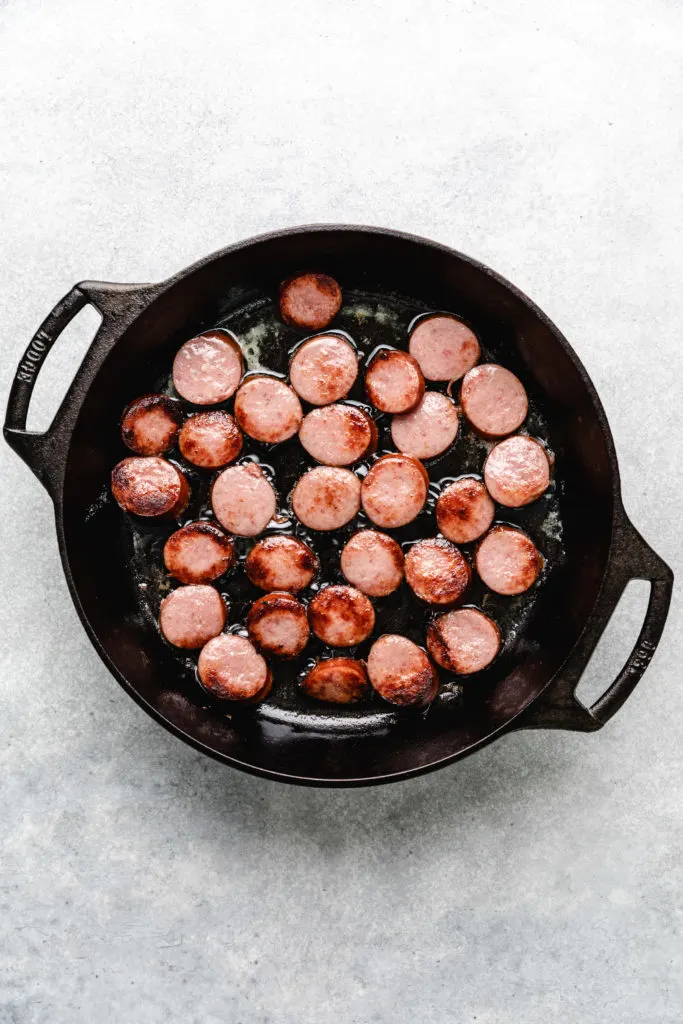 Sausage cooking in a pan.