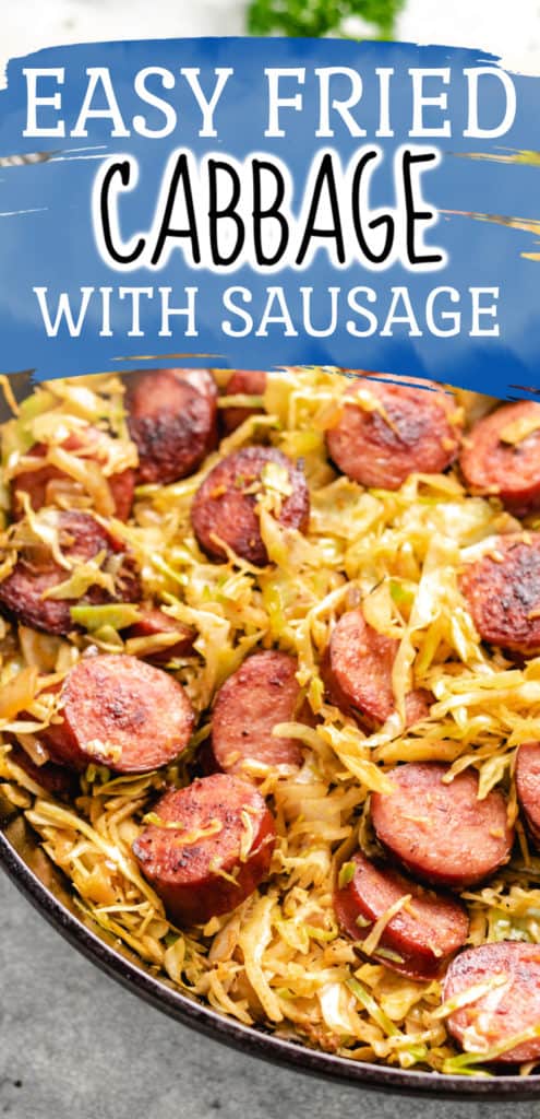 Close up view of shredded cabbage and sausage in a dish.