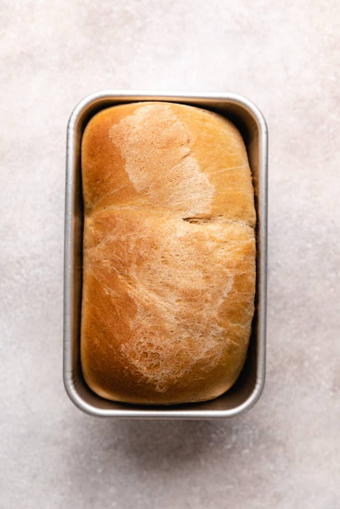 Baked honey wheat bread in a pan.