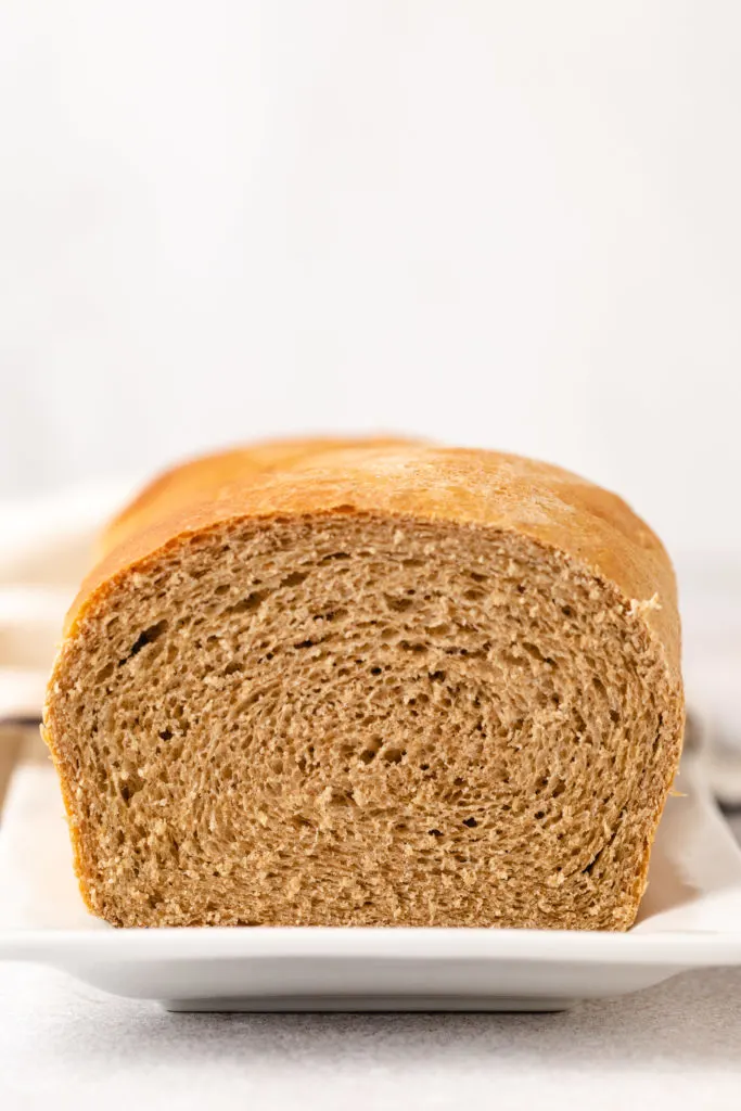 Side view of a sliced loaf of bread.