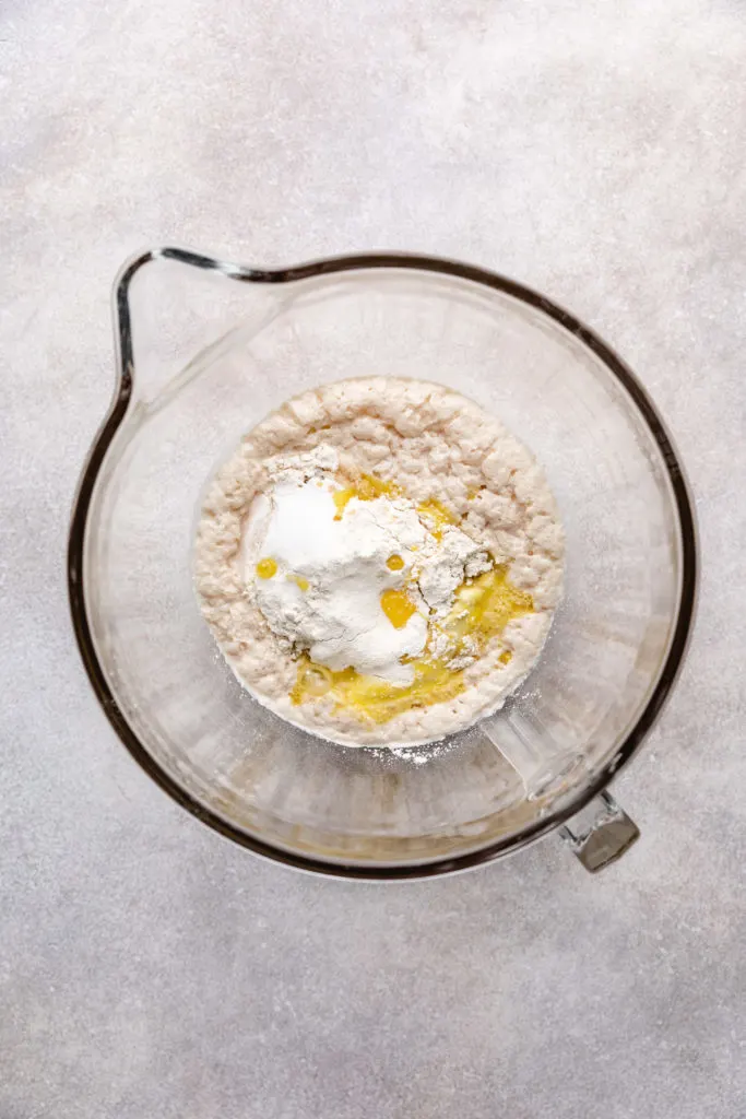 Egg, oil, flour, and activated yeast in a bowl.