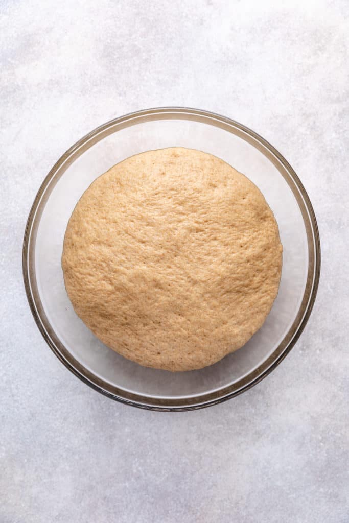 Risen bread dough in a bowl.