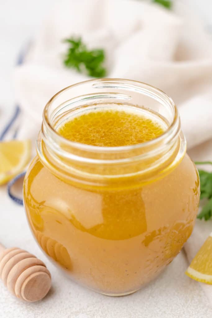 Honey lemon salad dressing in a glass jar.